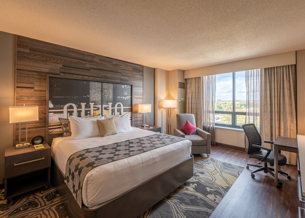 a hotel room with a bed and chair